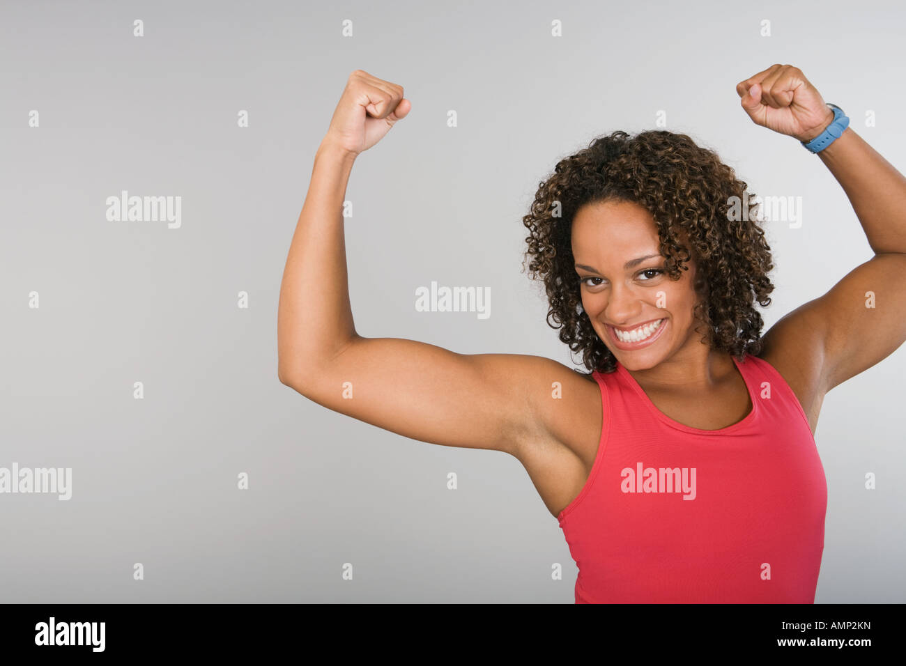 Muscular woman flexing her arm Stock Photo - Alamy