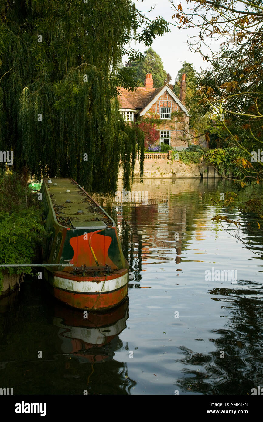 Old narrow boat moored in a quiet back water above the weir at Goring
