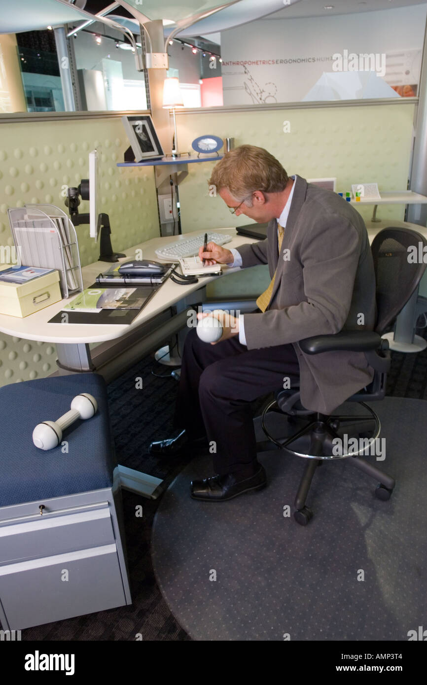 Adult businessman lifting weights at his desk Stock Photo Alamy