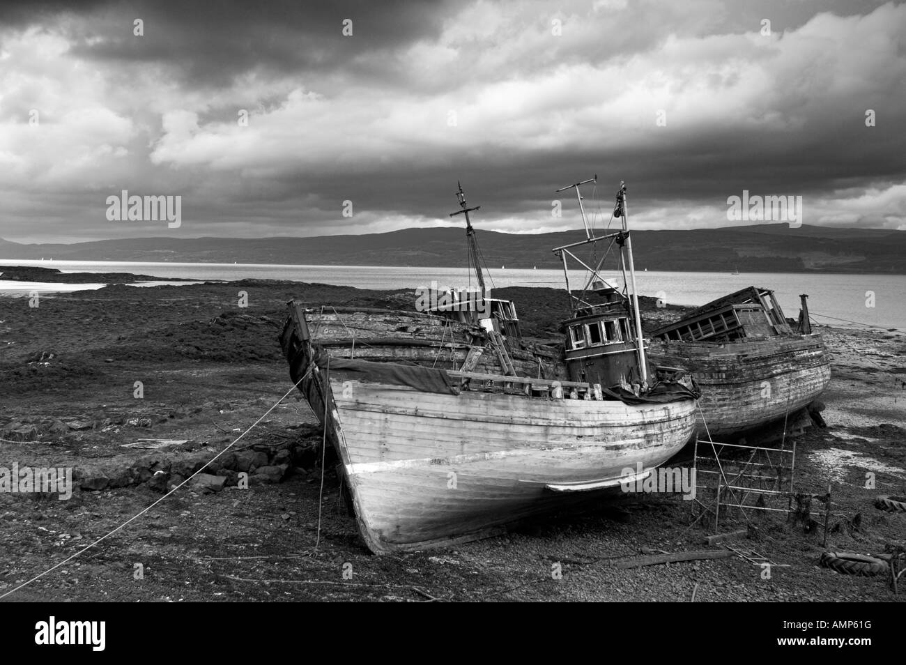 Wrecked fishing boats in gathering storm Isle of Mull Inner Hebrides Scotland United Kingdom GB UK Europe Stock Photo