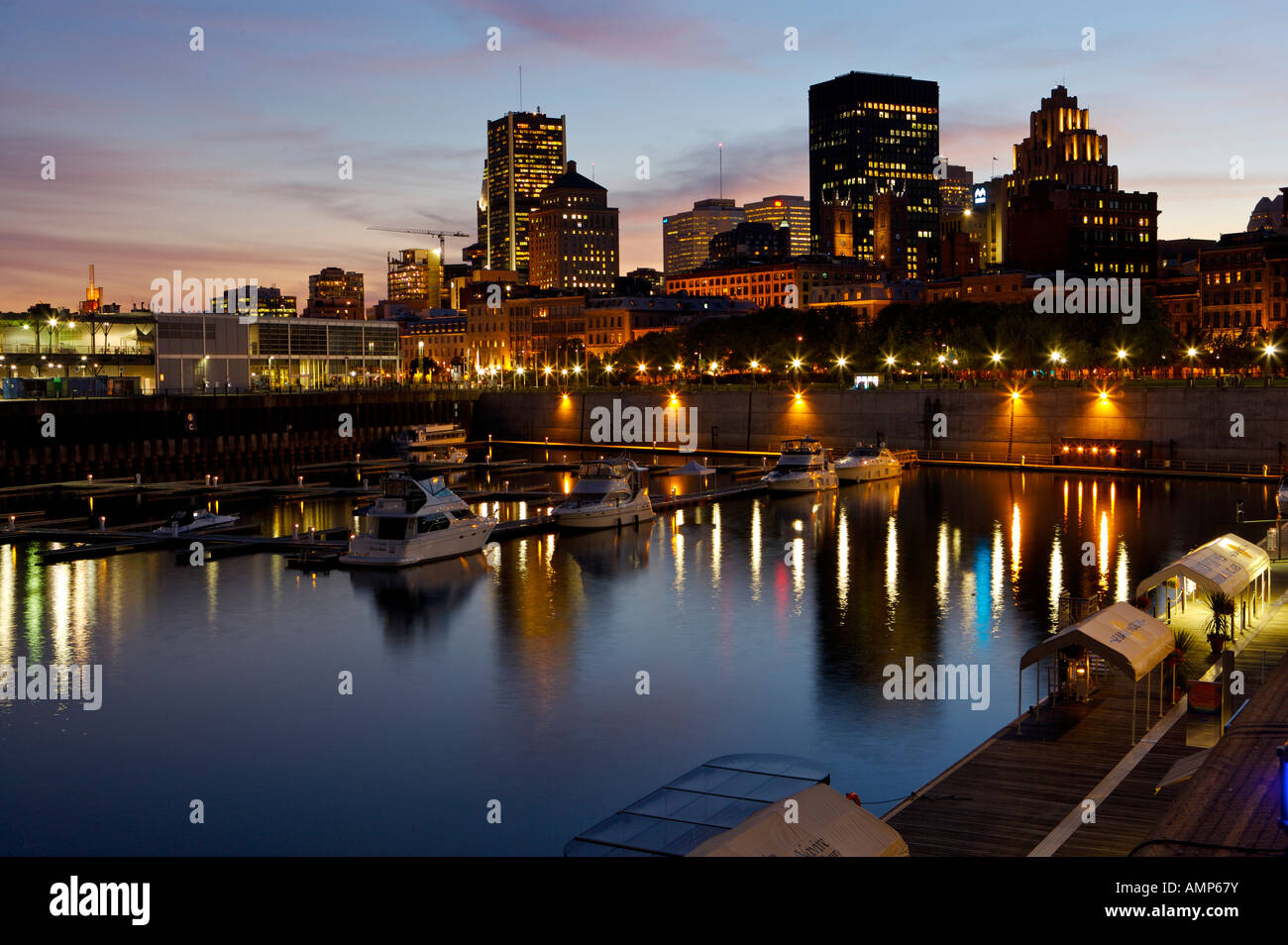 Downtown Montreal seen from the Jacques-Cartier Basin in Old Montreal and Old Port at night, Montreal, Quebec, Canada. Stock Photo