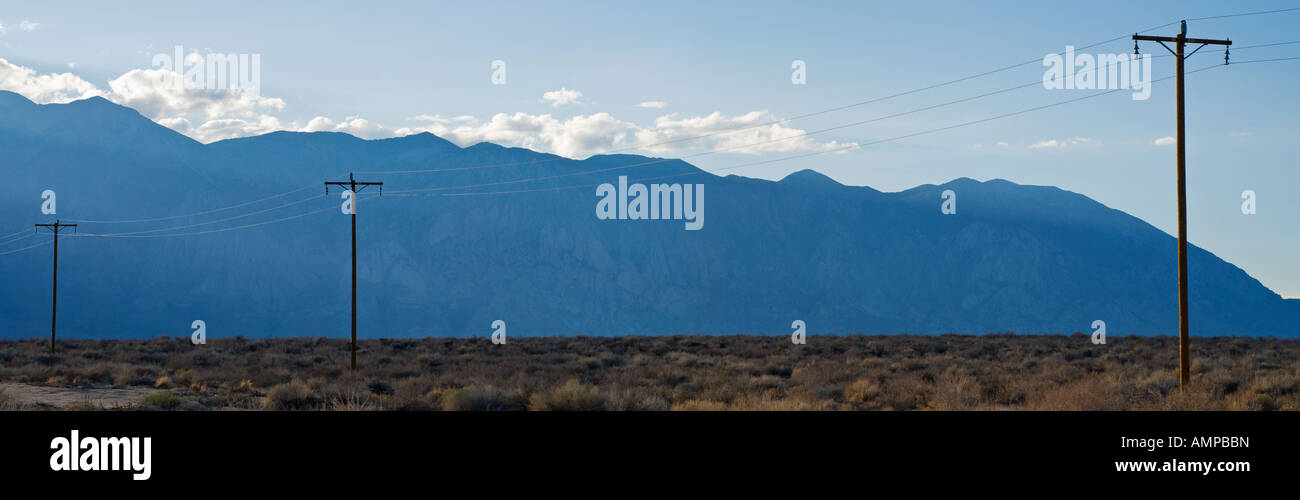 Panoramic of telephone poles with Sierra Nevada Mountains in background, Bishop, California Stock Photo