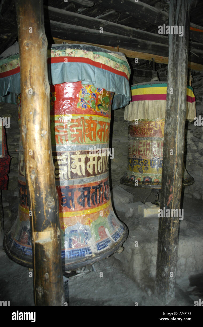 Very old prayer wheels with coloured Nepali script Braga Gompa Annapurna Region Nepal Stock Photo
