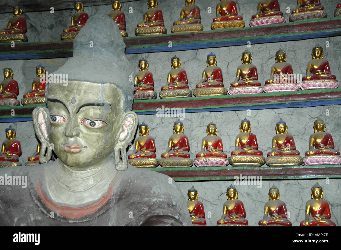 Statue of Buddha with many small Buddha figures Braga Gompa Annapurna Region Nepal Stock Photo
