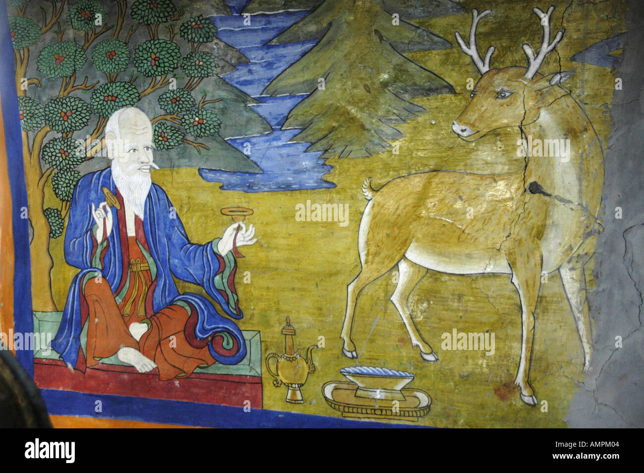 Wall painting of a meditating man and a deer in a temple Muktinath Mustang Annapurna Region Nepal Stock Photo