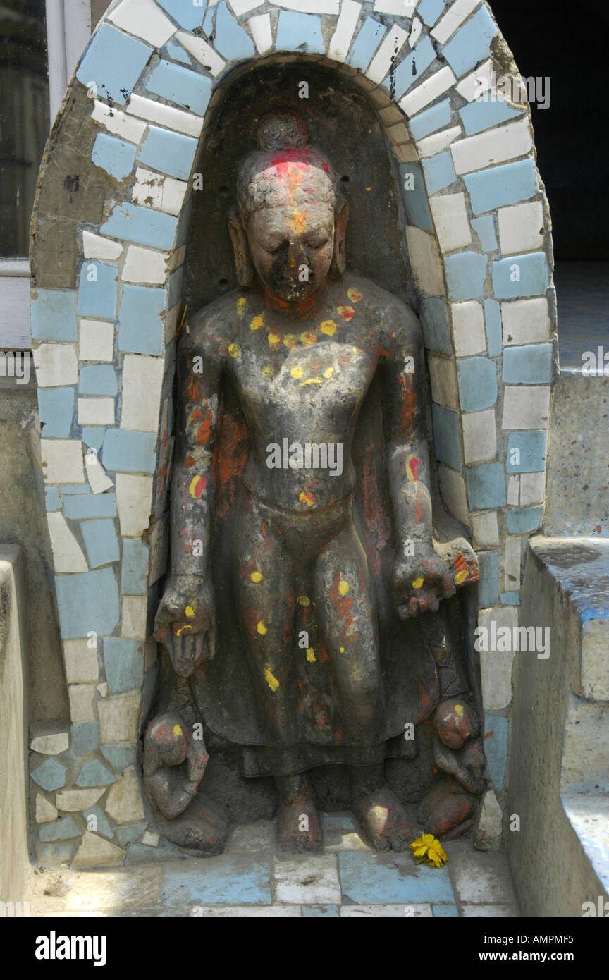 Old Buddha figure framed by blue and white tilework Kathmandu Nepal Stock Photo