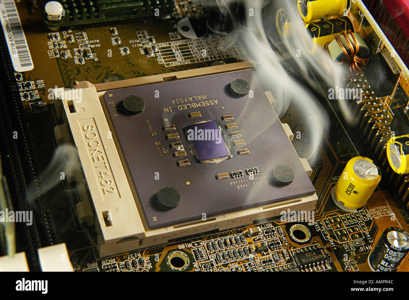 A CPU smoking through overheating Stock Photo - Alamy