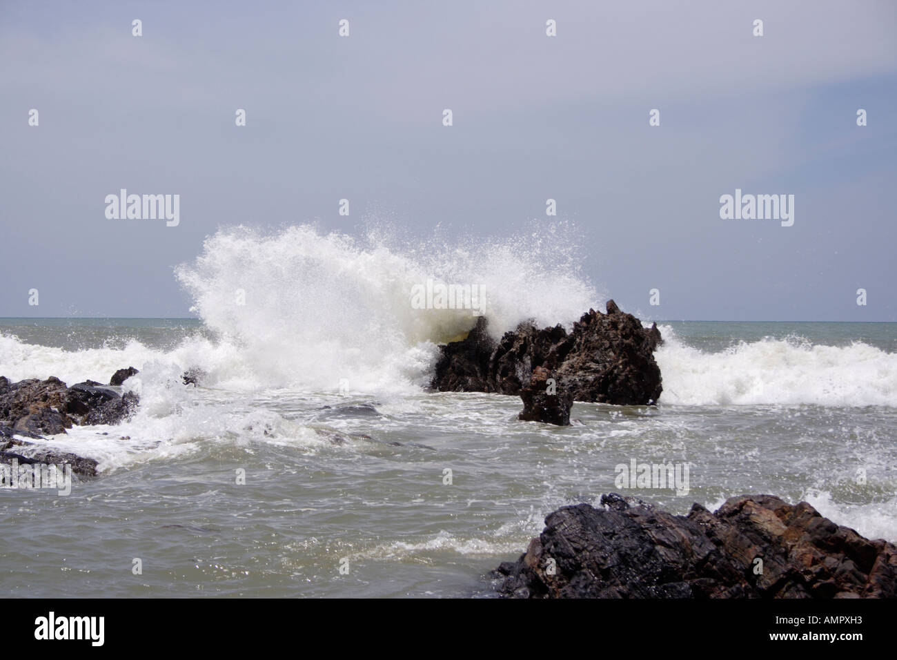 Powerful wave crashing against a rock in Terengganu, Malaysia. Stock Photo