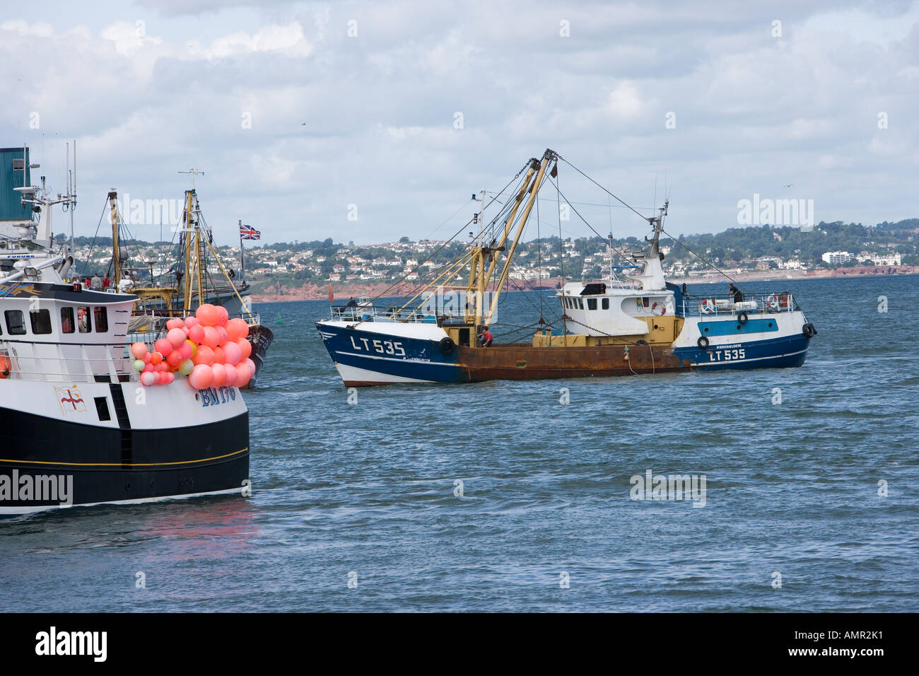 Trawler entering Brixham Harbour, Devon Stock Photo