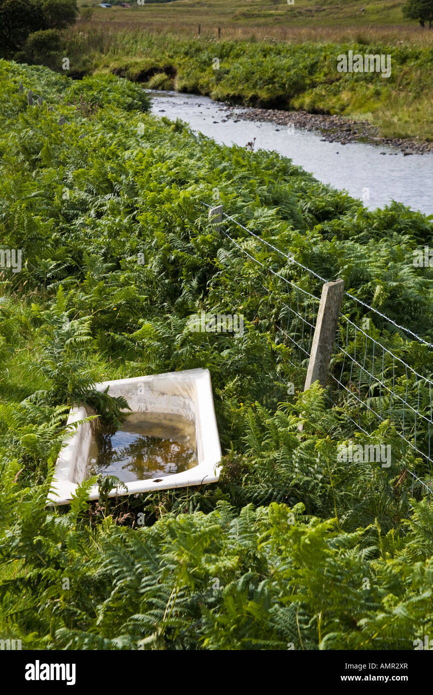 An old bathtub filled with water in a field on the Isle of Skye