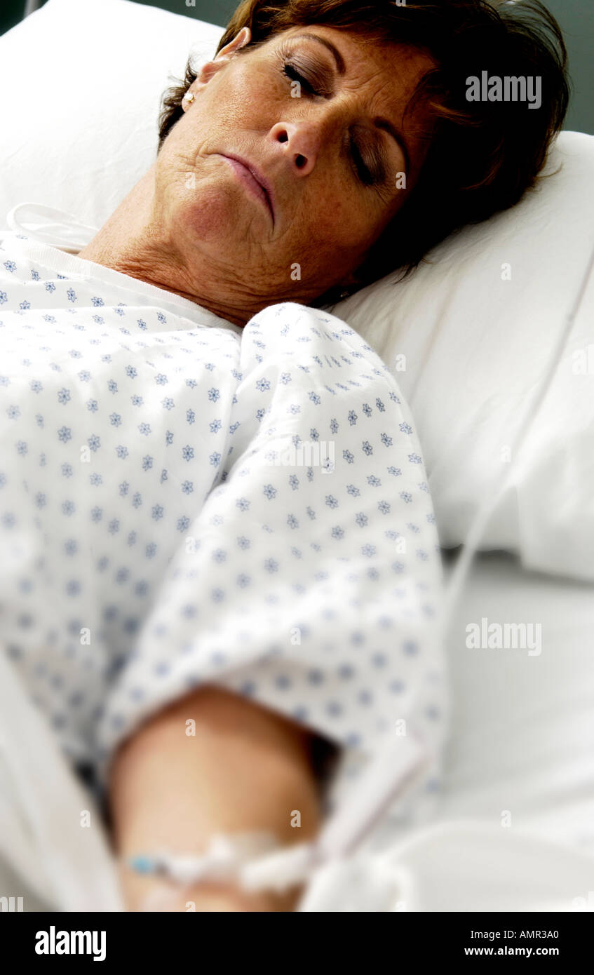 Patient in hospital bed Stock Photo