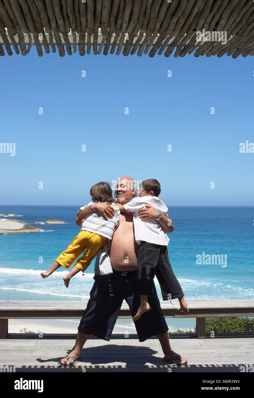 Download Grandfather Playing With Grandsons At The Beach Stock Photo Alamy