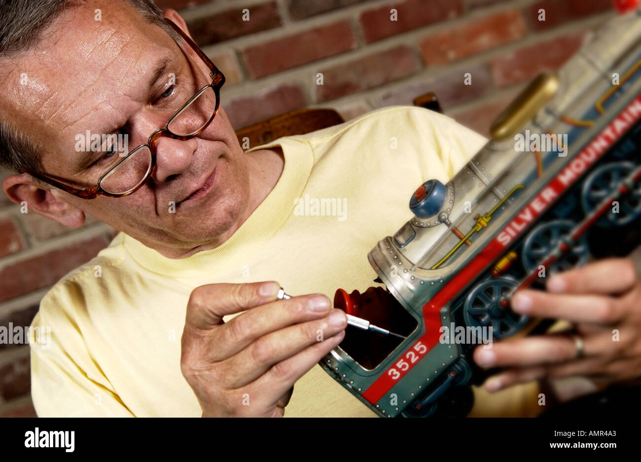 Man repairing a model train Stock Photo Alamy