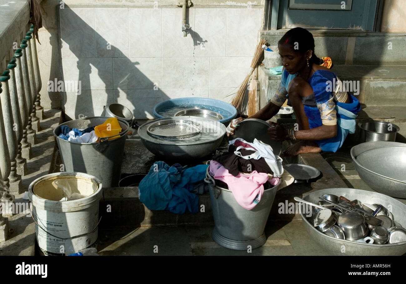 An Indian lady washes dishes and clothes at her home in Navsari, Gujarat, India, Asia Stock Photo