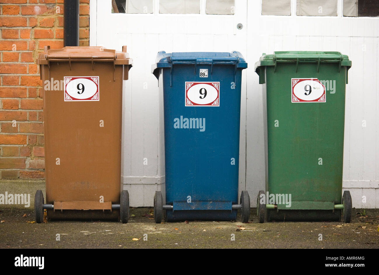 Three different coloured bins outside hires stock photography and