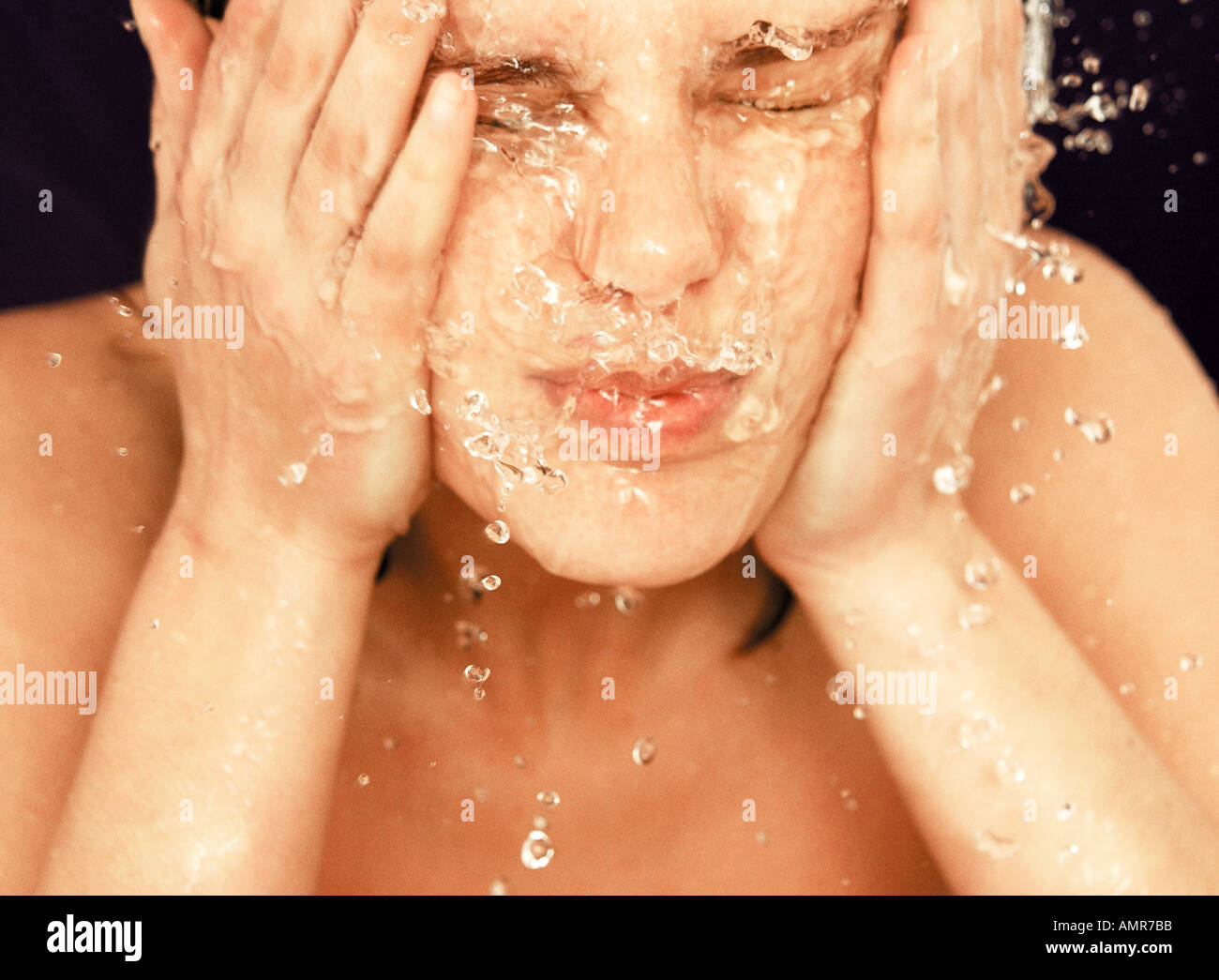 Woman splashing her face with water Stock Photo Alamy