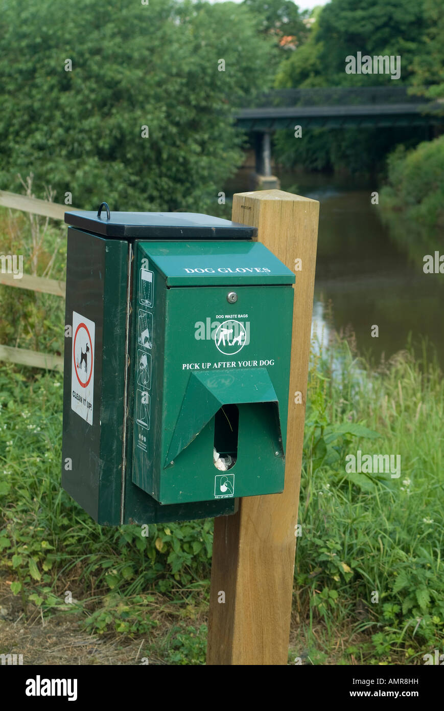 Dog faeces bin and glove dispenser on the side of the river Derwent in