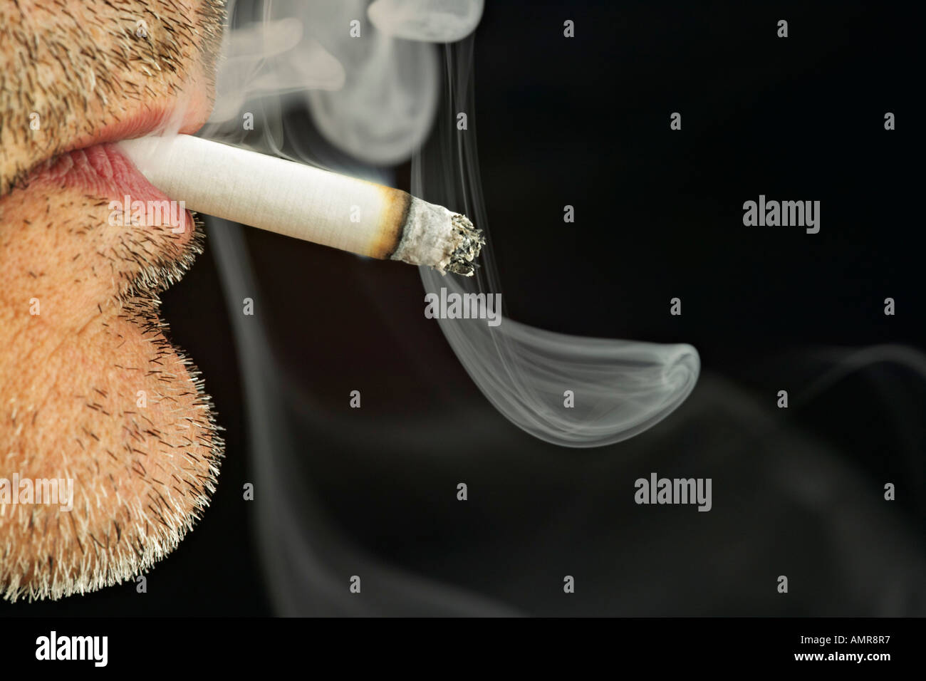Close Up of Man Smoking Cigarette Stock Photo
