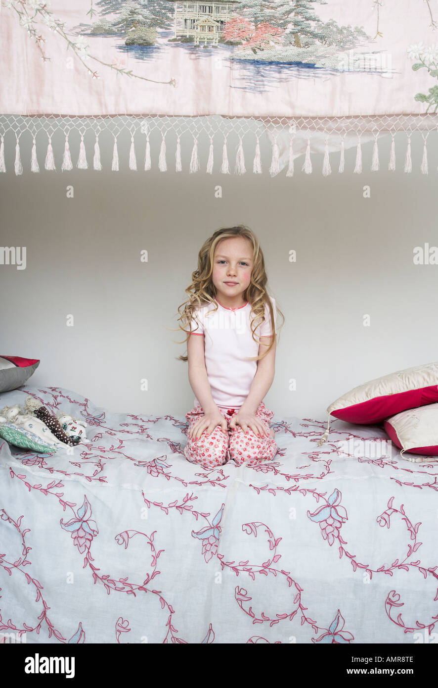 Portrait of Girl Sitting on Bed Stock Photo - Alamy