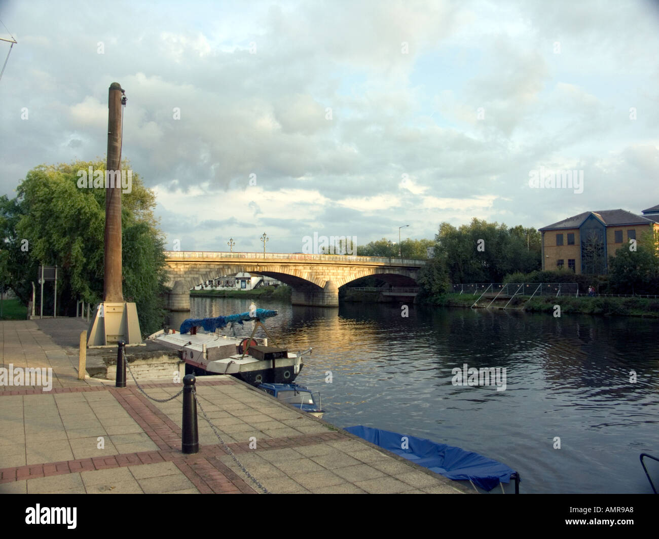 Barge moored on the River Thames, Staines, Middlesex, England, Roman Stone Bridge in background