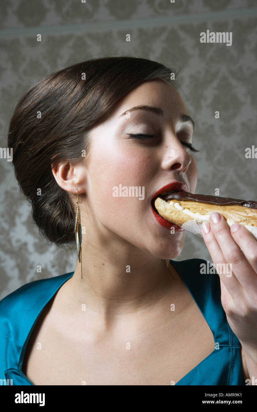 Woman Eating Eclair Stock Photo