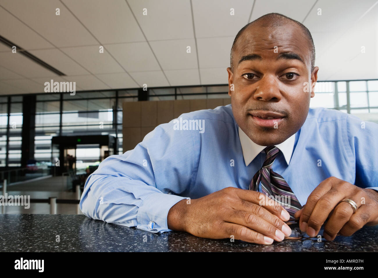 African businessman leaning on counter Stock Photo