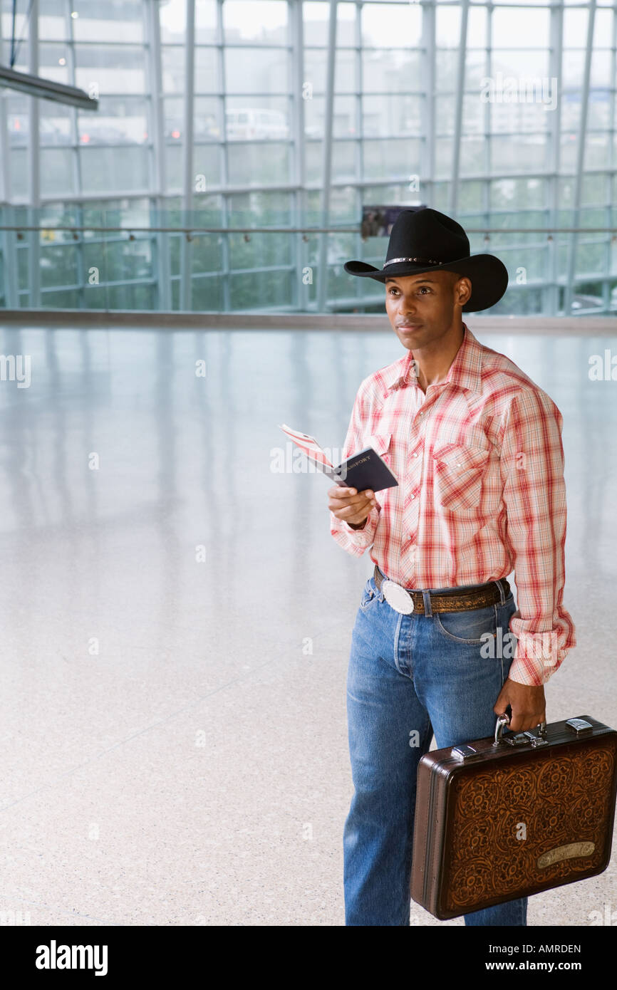 African man in cowboy hat at airport Stock Photo