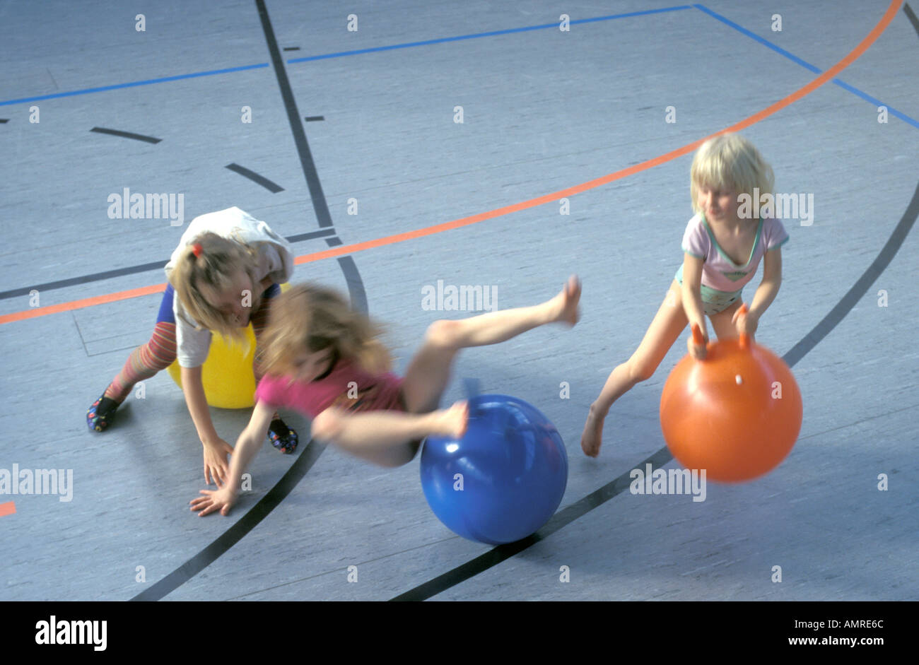 Girls jumping on rubber balls Stock Photo Alamy