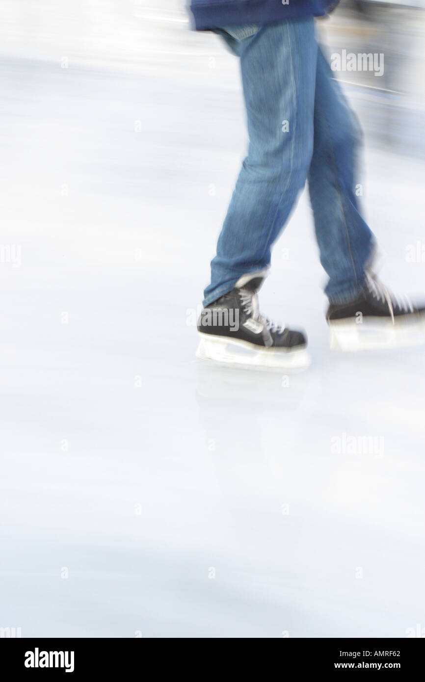 Skater skating blades on frozen ice Stock Photo Alamy
