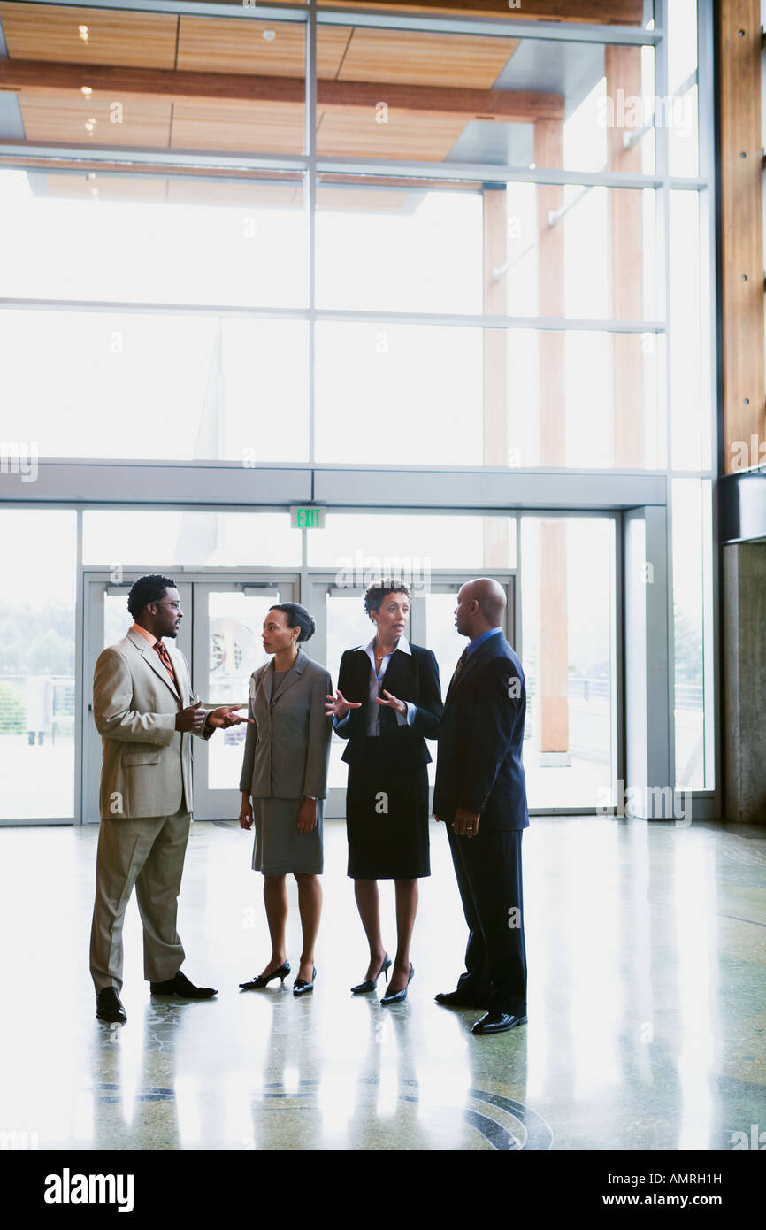 African businesspeople talking in lobby Stock Photo