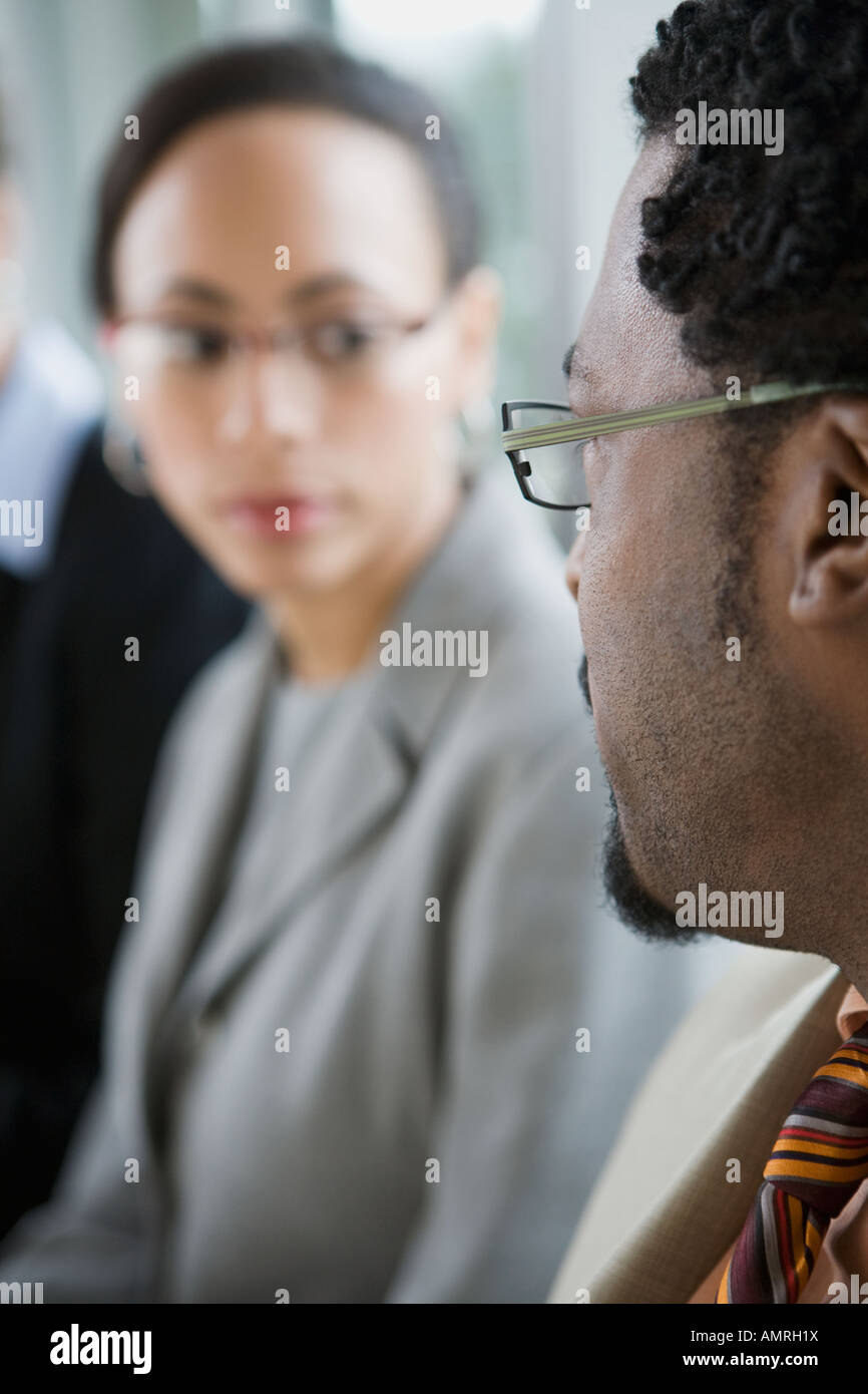 African businessman looking at coworker Stock Photo