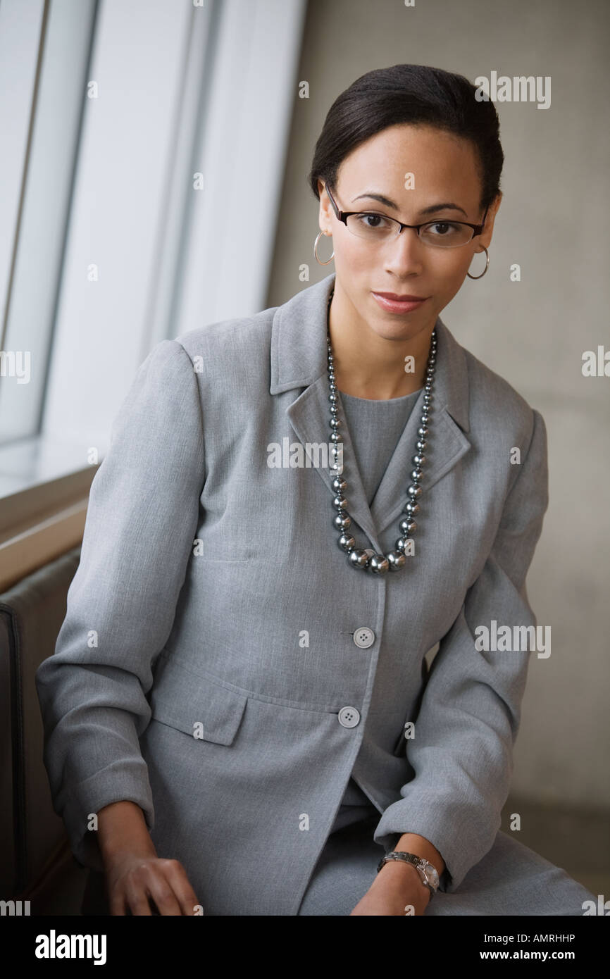 African businesswoman wearing necklace Stock Photo