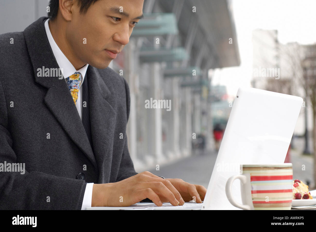 Businessman Using Laptop Computer At Cafe Stock Photo