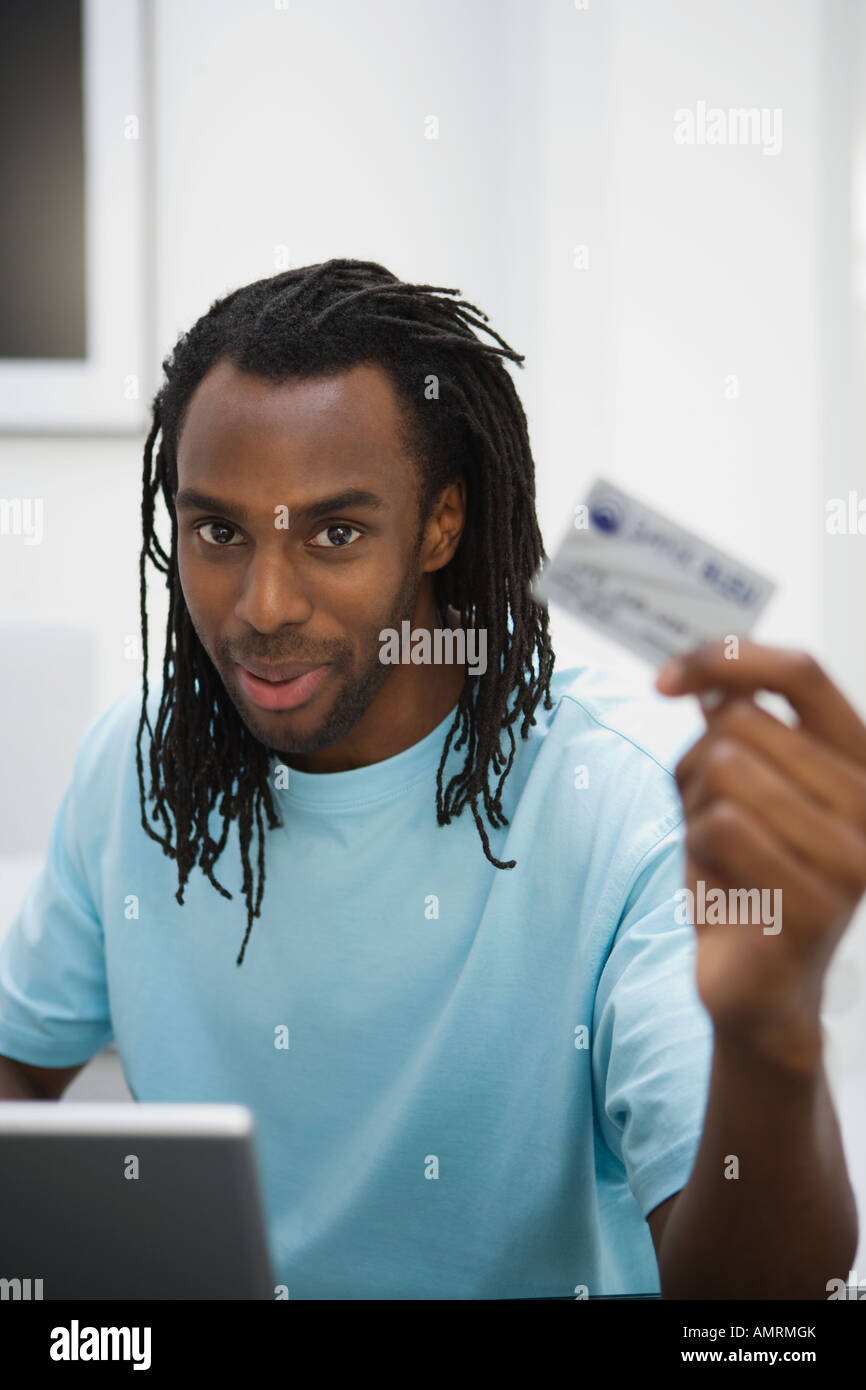 African man holding credit card Stock Photo - Alamy