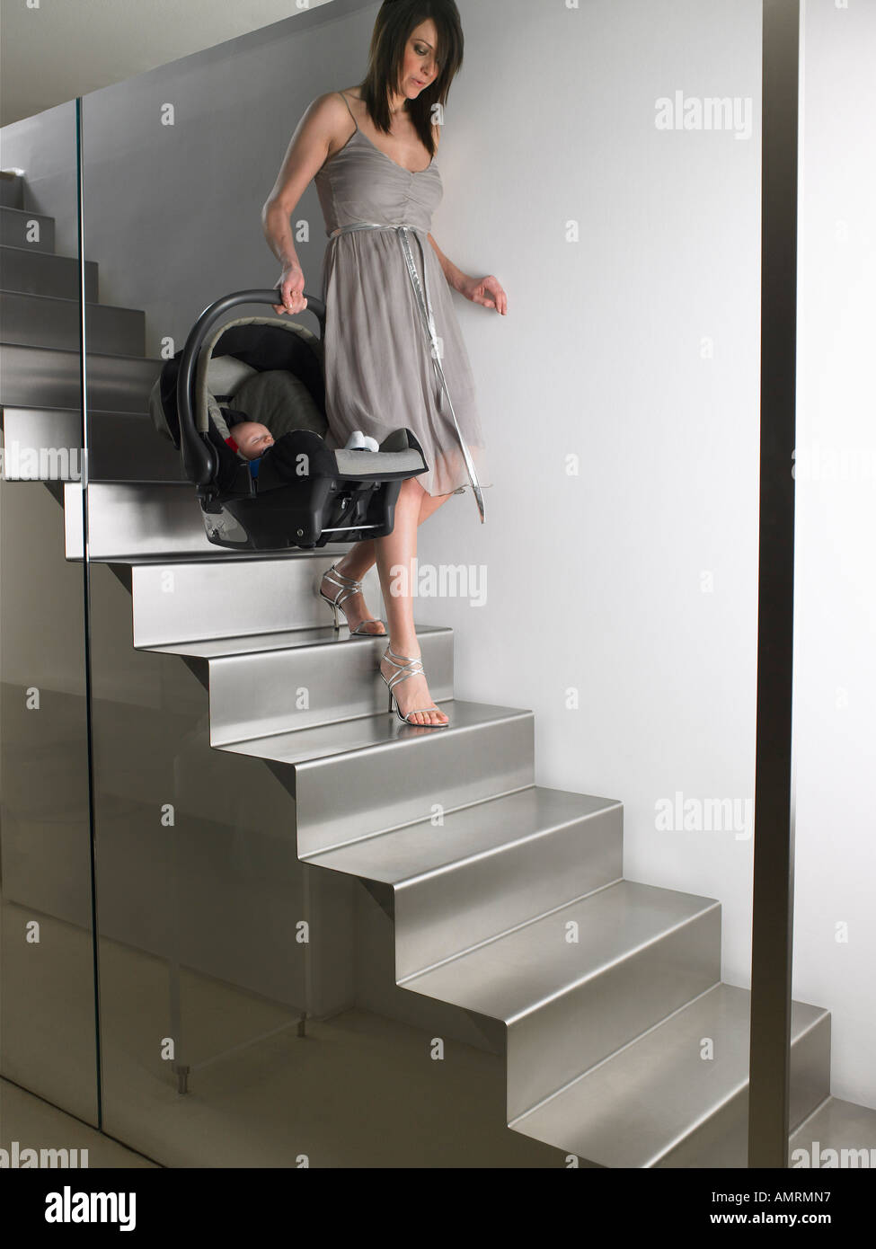 Mother Carrying Baby Down Stairs Stock Photo Alamy