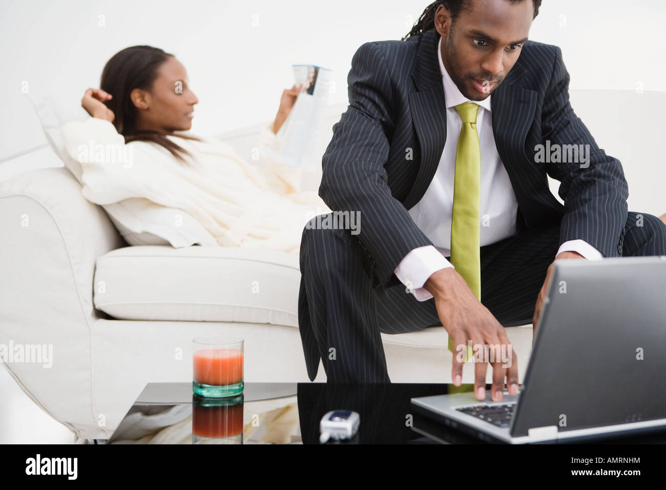 African couple relaxing on sofa Stock Photo - Alamy