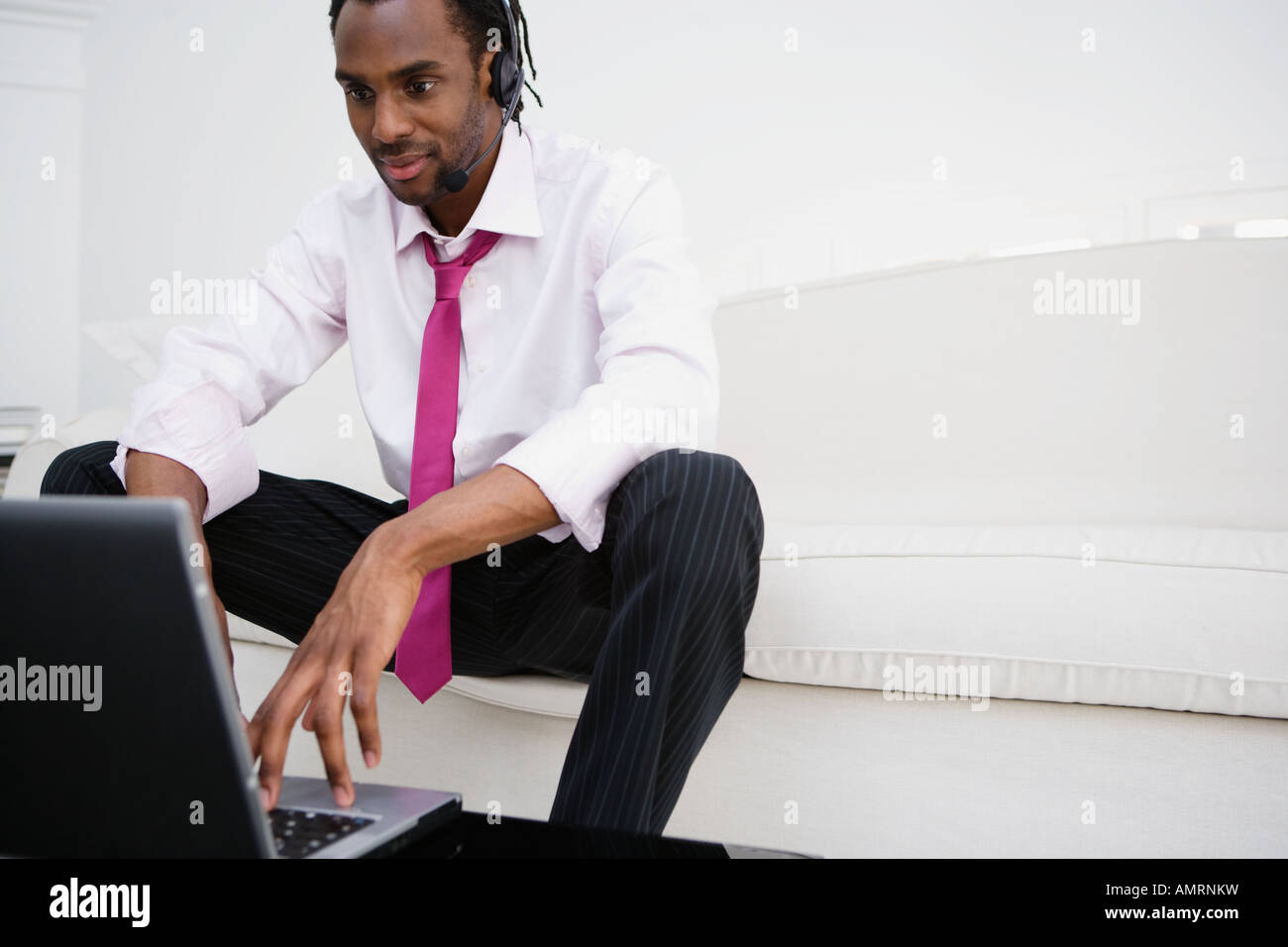 African businessman typing on laptop Stock Photo