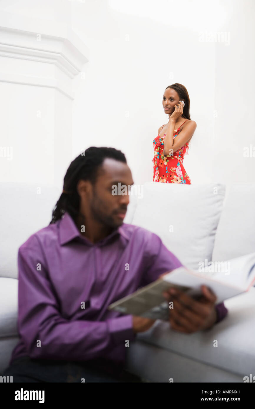 African couple relaxing in living room Stock Photo
