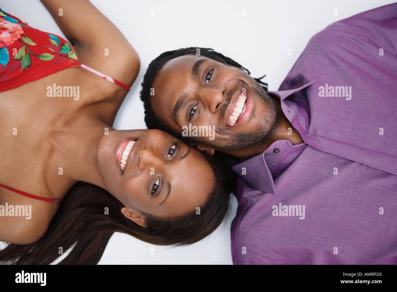 African couple laying on floor Stock Photo