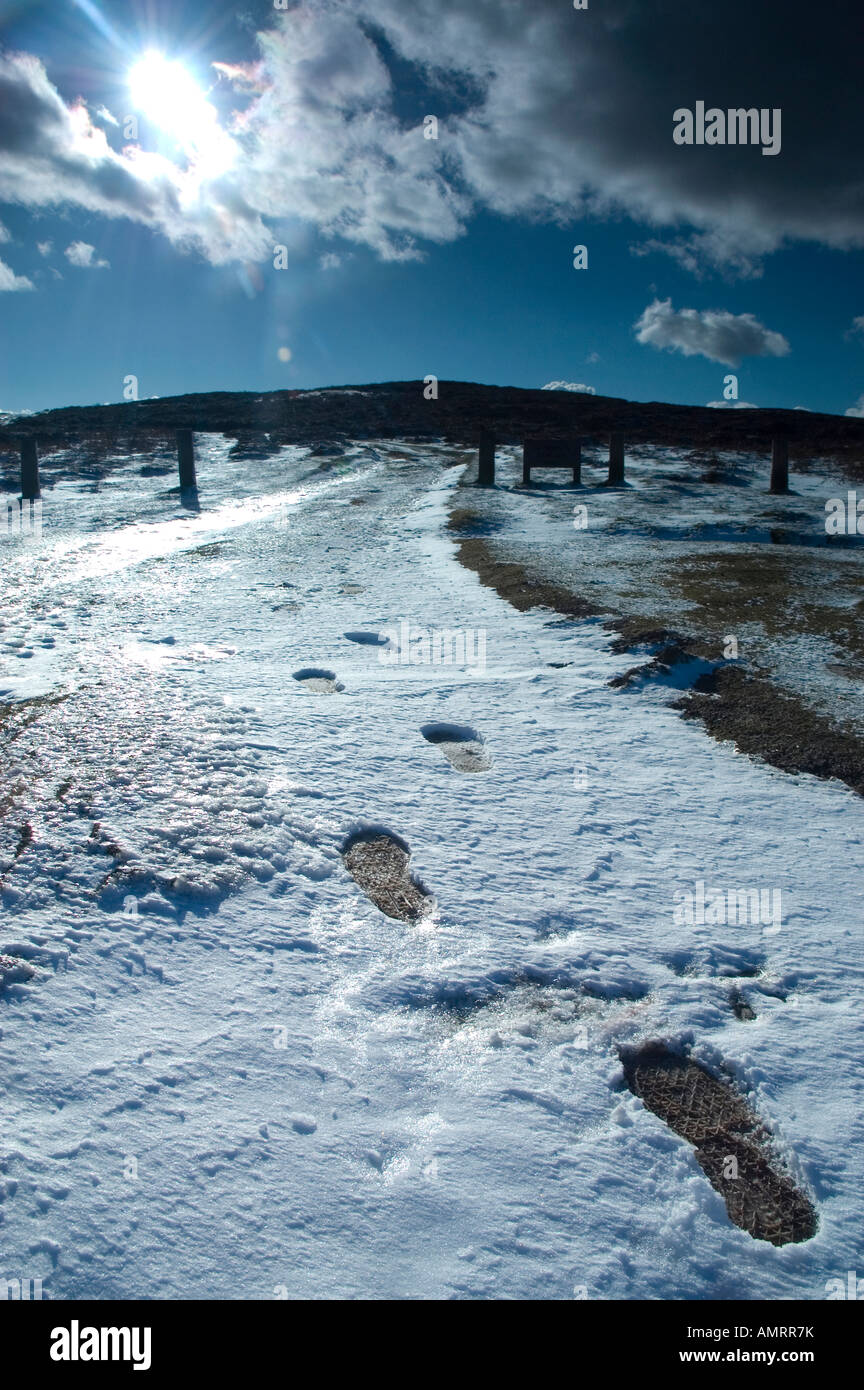 Steps In Snow Winter scene of snowy path leading up hill with footsteps in the snow ...