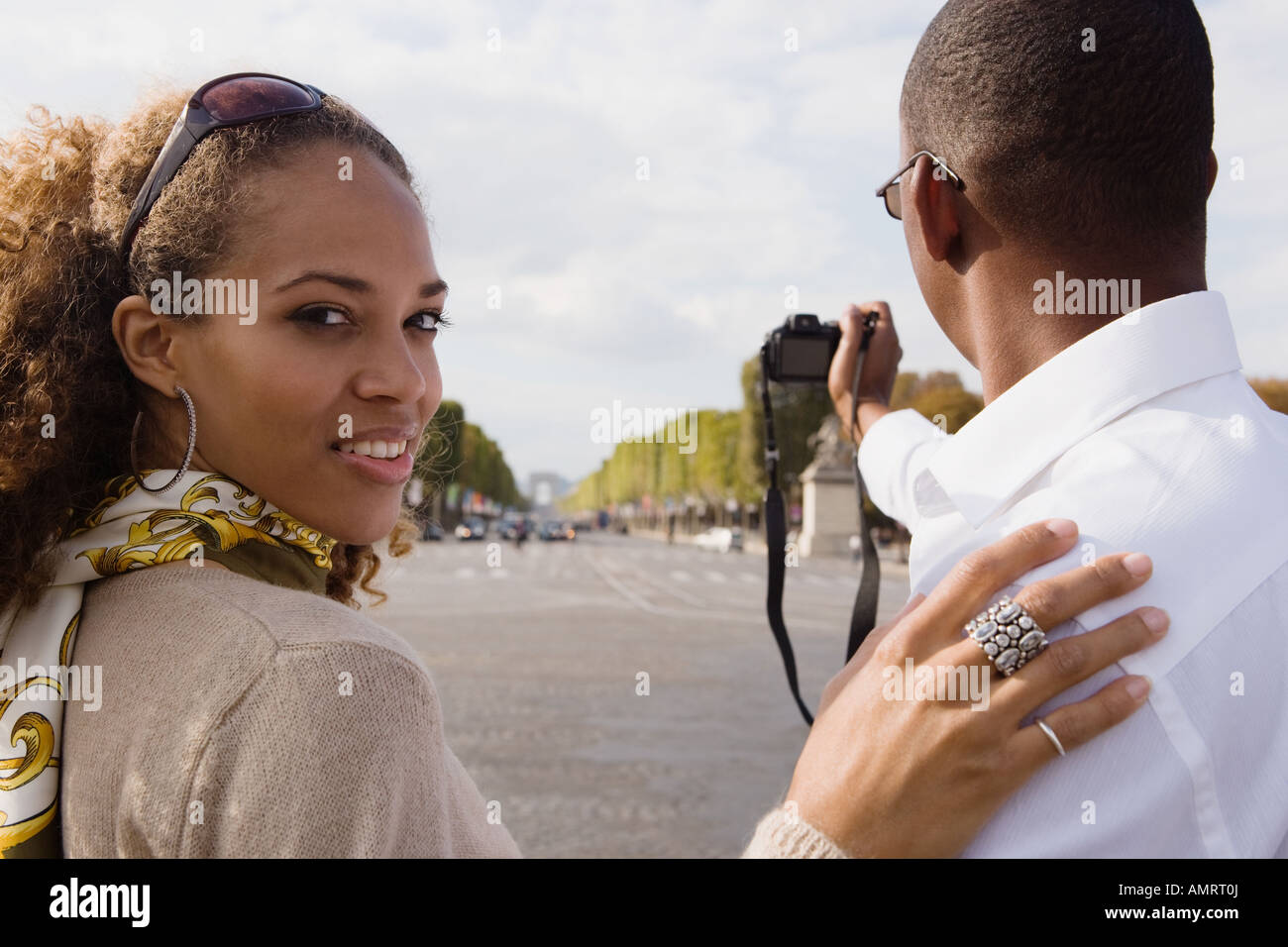 African couple taking photograph Stock Photo - Alamy