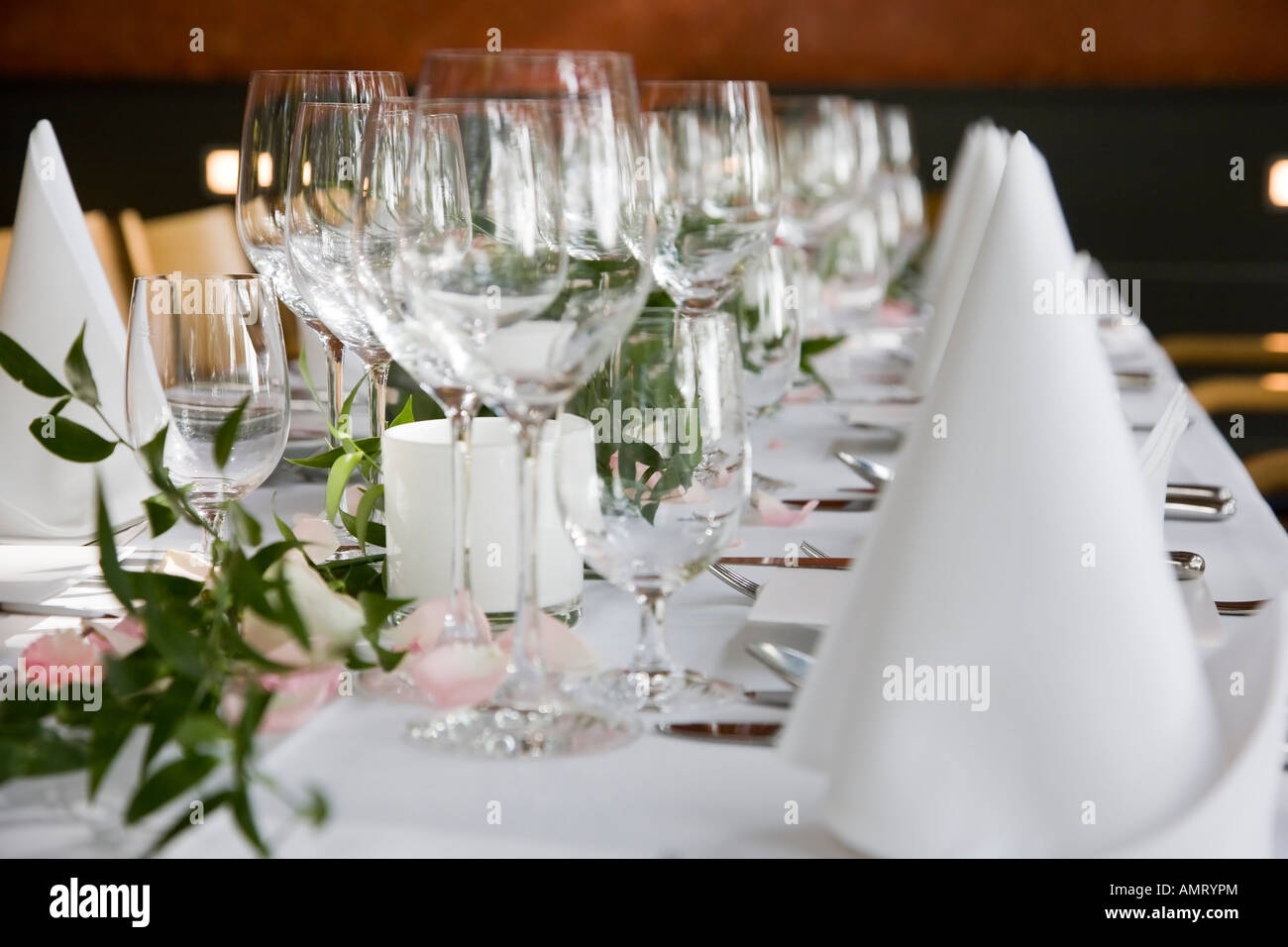 Welllaid table with white folded serviettes and wine glasses Stock