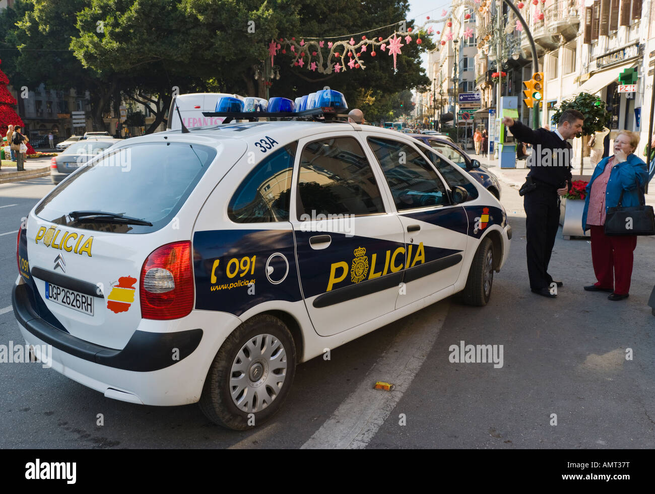 Malaga Costa del Sol Spain National policeman giving directions to woman Stock Photo