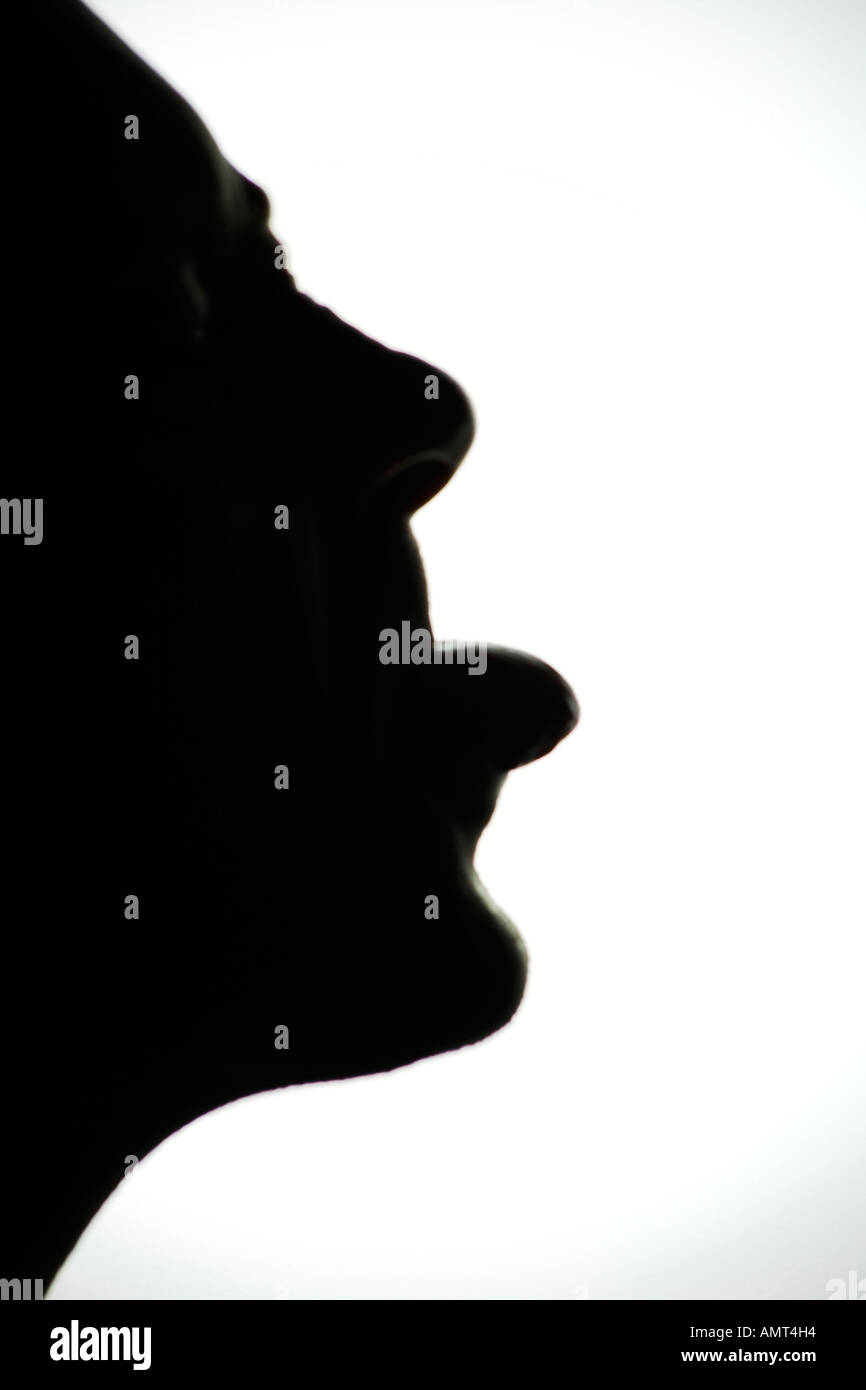 Moody humerous shot of a face profile silhouette with tongue sticking out Stock Photo