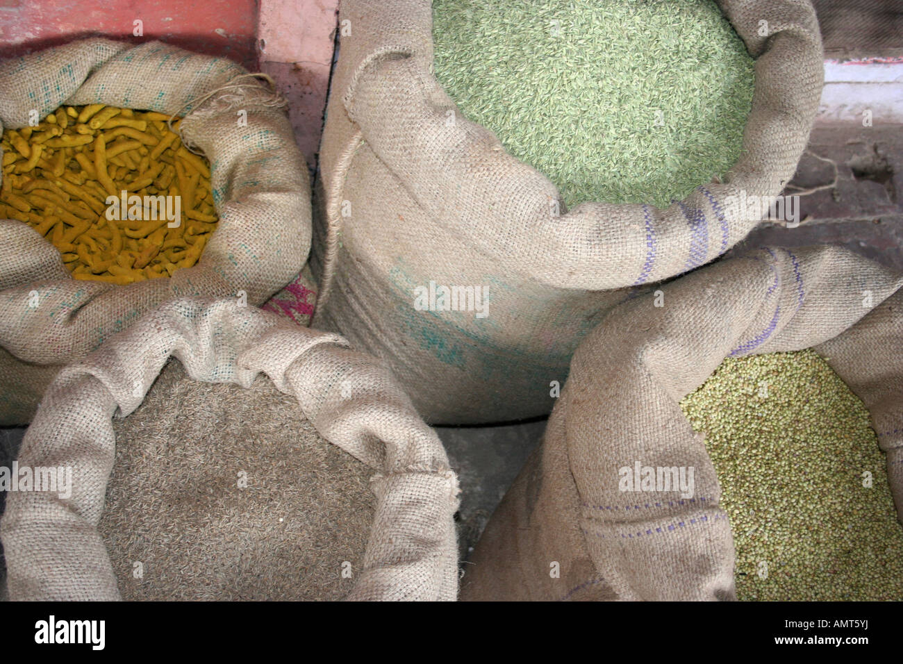 Sacks of turmeric, rice and different grains on display outside a shop in Jaipur, India Stock Photo