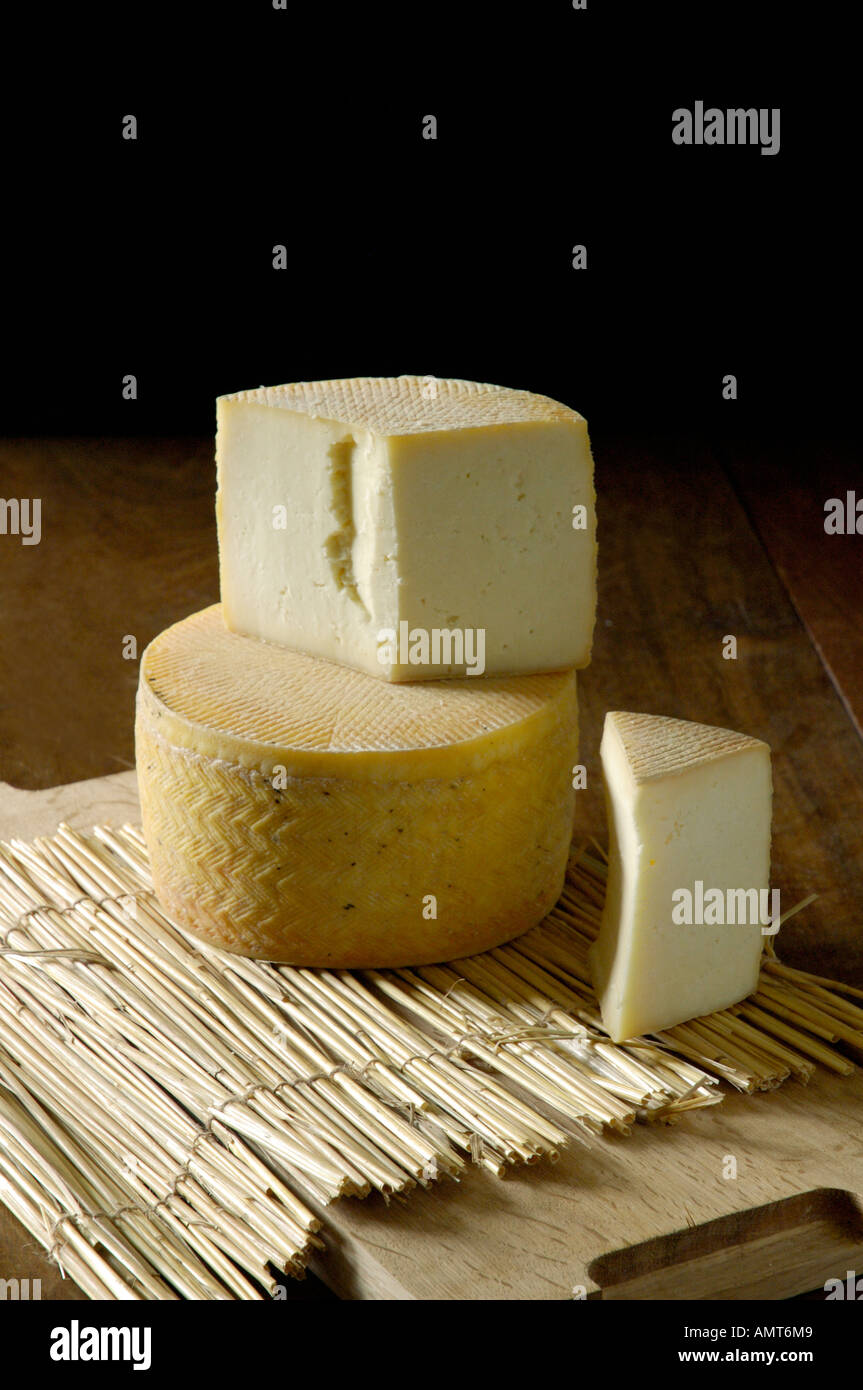 Cheese rounds on rustic table Stock Photo - Alamy