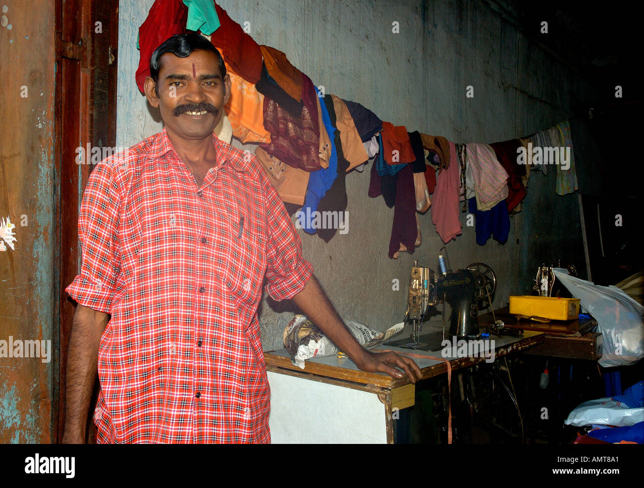 Indian man sewing on street in Trivandrum Thiruvananthapuram Kerala