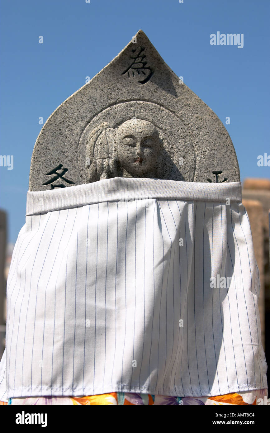 A wrapped figurine in the graveyard at Shitenoji Osaka Japan Stock Photo
