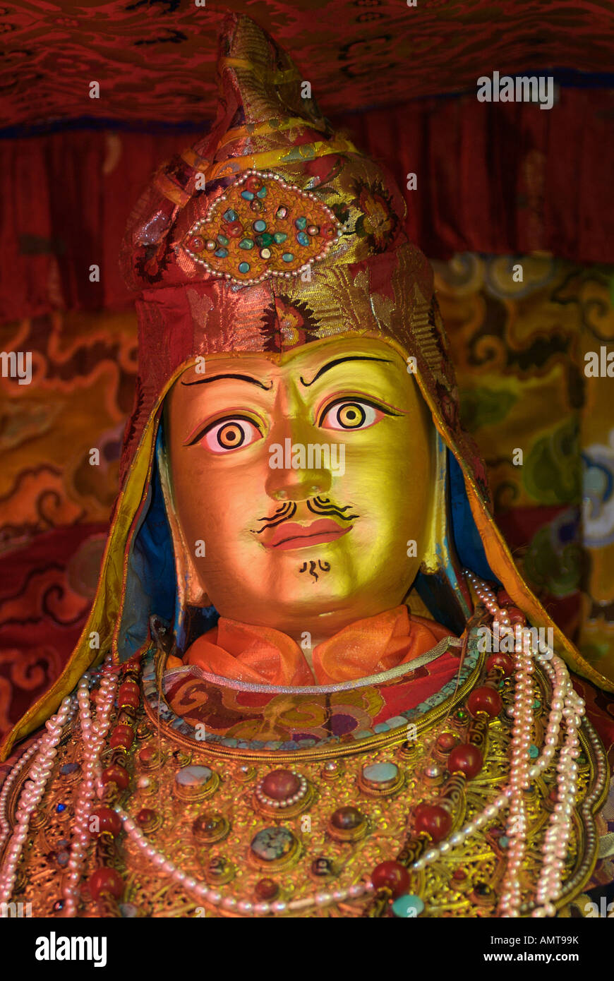 Detail of ornately carved gilded Buddhist statuary of a previous Dalai Lama in Samye Monastery Tibet Stock Photo