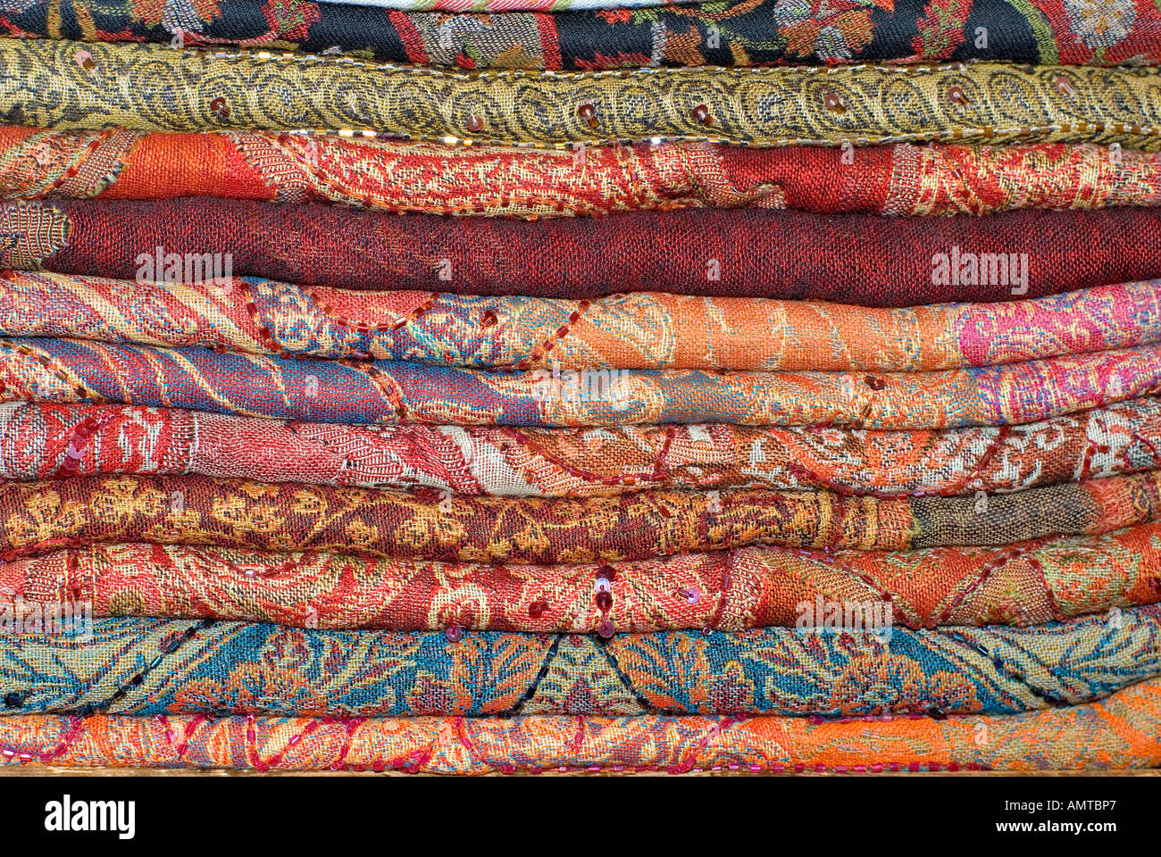 Stack of woven silk brocaded fabrics from India Stock Photo